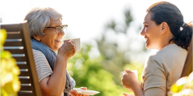 companionship visitor drinking coffee with elder