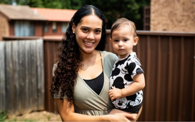 confident-young-mother-holding-baby