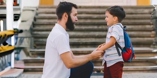 father sending son to school and talking