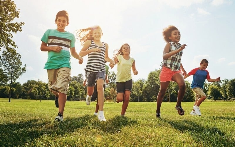 happy friends children running in park for fun