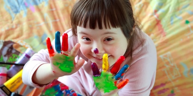 kid-with-her-hands-pained-in-color