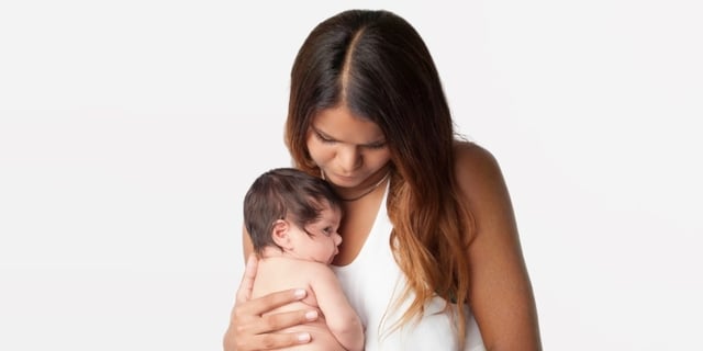 mother holding new born baby