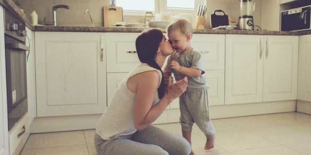 mum-kissing-kid-in-kitchen