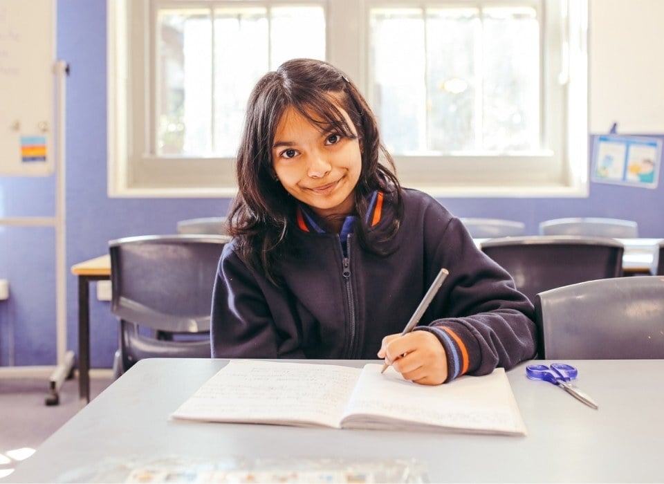 school kid writing learning new skills in school