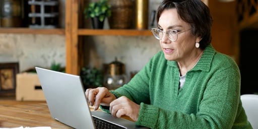 senior woman on laptop searching digital community