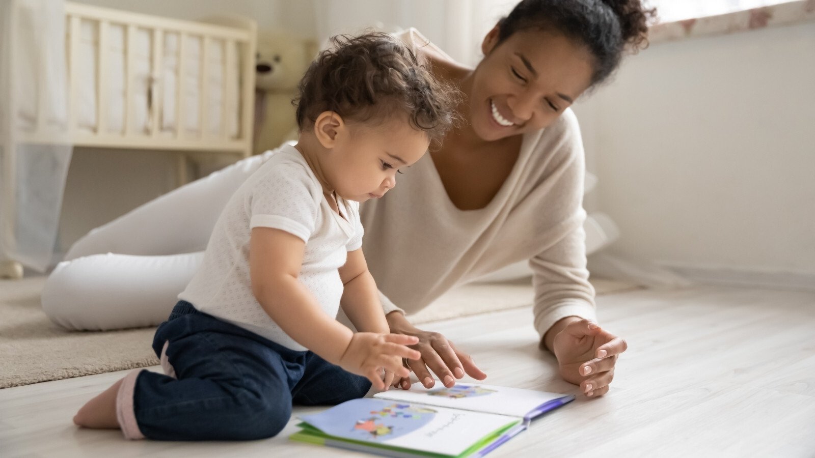 mother-playing-reading-book-to-baby