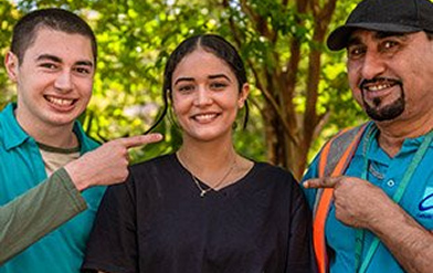 Three people smiling