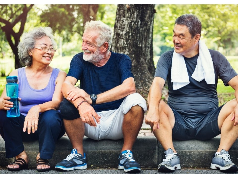 ageing well group exercising in park