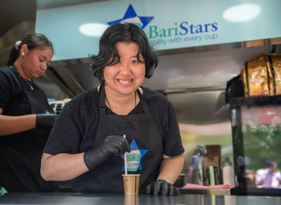 female-disability-barista-making-coffee-in-baristars-coffee-cart