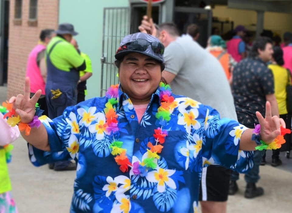 jouful disability worker in colorful clothes attending event