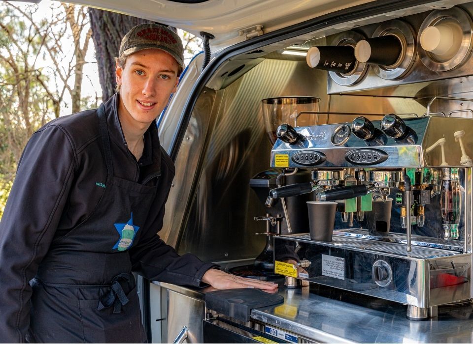 young BariStar with coffee machine in coffee cart