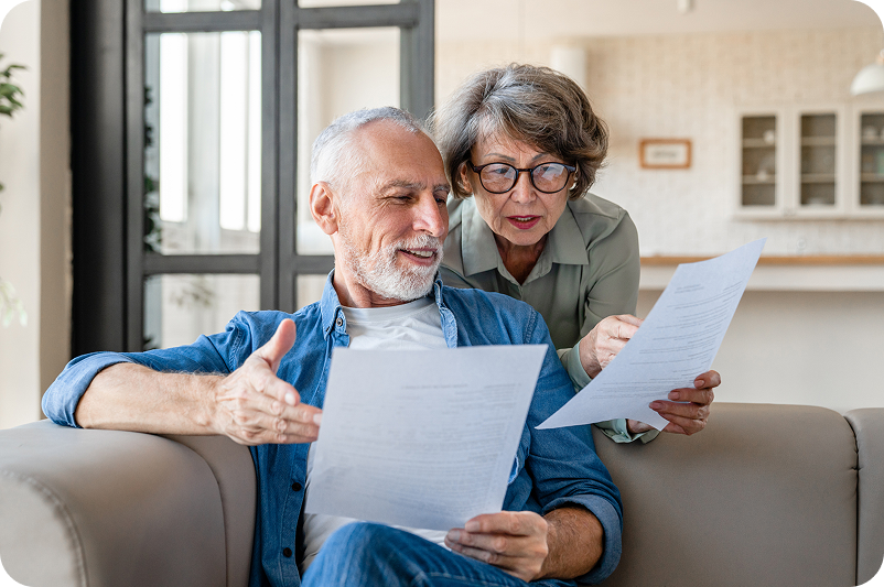 Image of a senior couple looking at printed documents