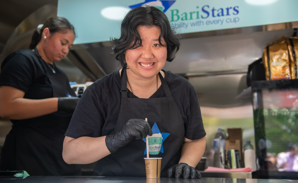 Thuy serves coffee at the BariStars opening