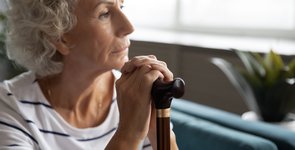 Thoughtful elder disabled woman sitting